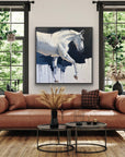 Living room with a brown sofa, coffee table, and horse painting on the wall.
