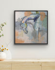 Framed abstract painting of a horse on a wall above a wooden shelf with decorative items.