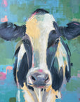 A colorful abstract painting of a cow's face