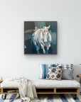 A casual living space with a painting of a white horse with a dark abstract background on a white wall.