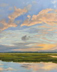 A landscape print featuring a serene sunset over a grassy terrain with aligned clouds in the sky.
