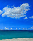 A landscape painting depicting a serene coastal scene with a blue sky, white clouds, and a calm ocean, framed in a natural floating frame.