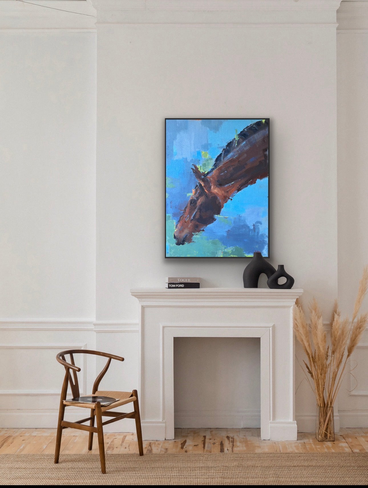 Painting of a horse head on a wall above a fireplace with decorative items.