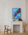 Painting of a horse head on a wall above a fireplace with decorative items.